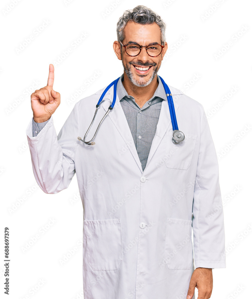 Middle age grey-haired man wearing doctor uniform and stethoscope pointing finger up with successful idea. exited and happy. number one.