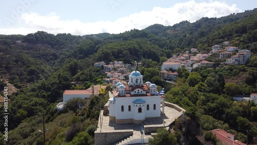 Aerial footage of typical Greek orthodox church on a mountain top in the Aegean island of Samos photo