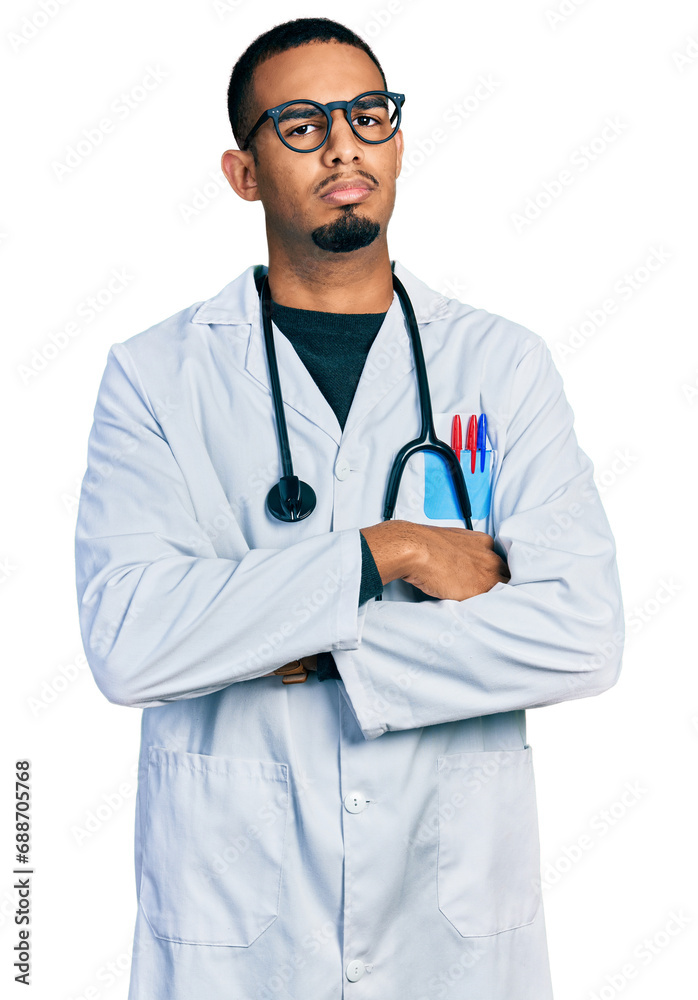 Young african american man wearing doctor uniform and stethoscope skeptic and nervous, disapproving expression on face with crossed arms. negative person. Young african american man wearing doctor uniform and stethoscope skeptic and nervous, disapproving expression on face with crossed arms. negative person.