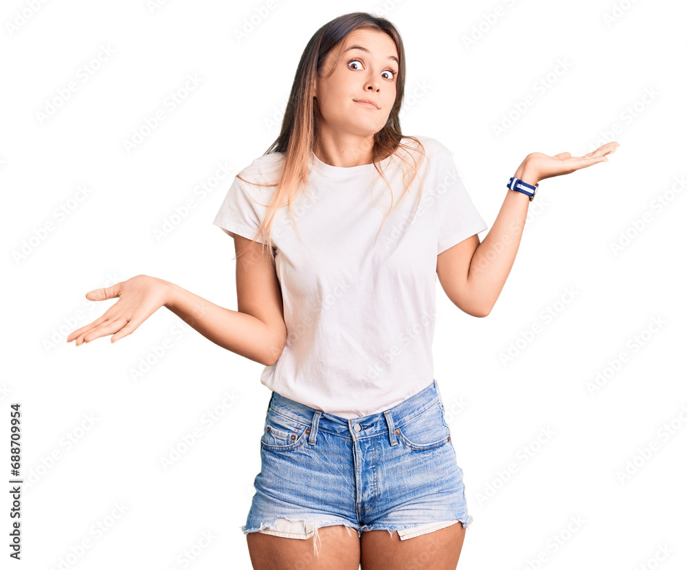 Beautiful caucasian woman wearing casual white tshirt clueless and confused expression with arms and hands raised. doubt concept.