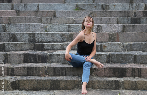 Fashionable beautiful woman on the steps of a summer day © Algimantas