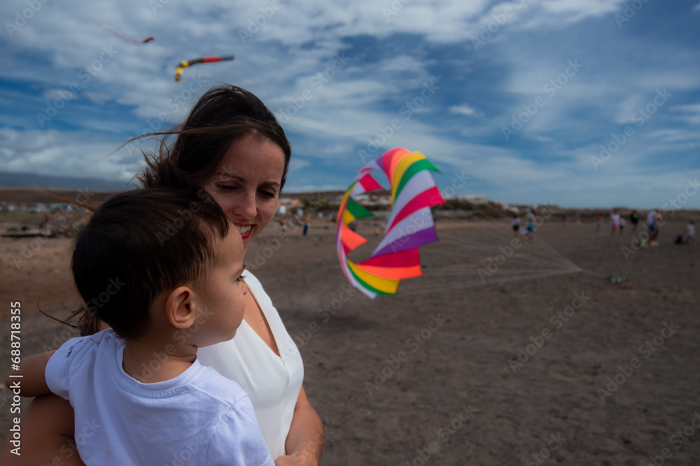 Mom looking at her son who sees a colorful kite