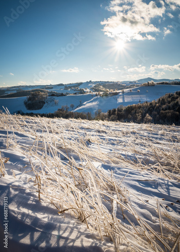 winter landscape with ice covered grass in the foregraound photo