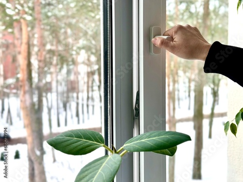 Opening the window for ventilation in winter. photo
