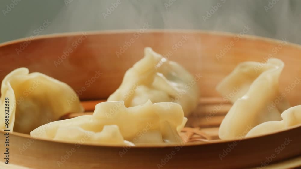Japanese gyoza on wooden steamer close-up. Fried dumplings with meat. Steaming Technique. Cooking at cafe, restaurant. Homemade. Delivery Japanese gyoza on wooden steamer close-up. Fried dumplings with meat. Steaming Technique. Cooking at cafe, restaurant. Homemade. Delivery