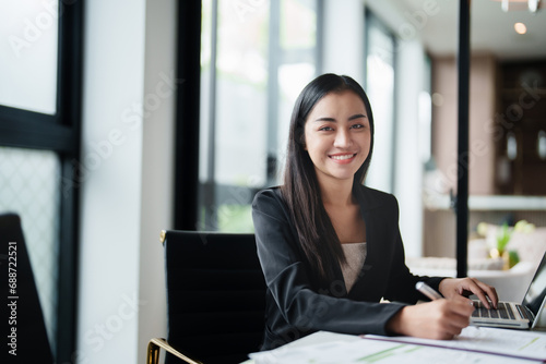 Free Download Portrait of asian woman working on desk at contemporary corporation office. - GFXLoad