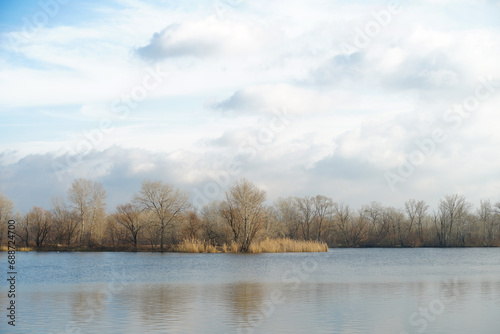 Sad autumn river landscape with cloudy sky