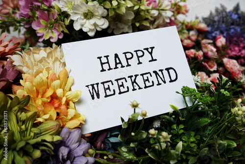 Happy Weekend text message on paper card with beautiful flowers decoration