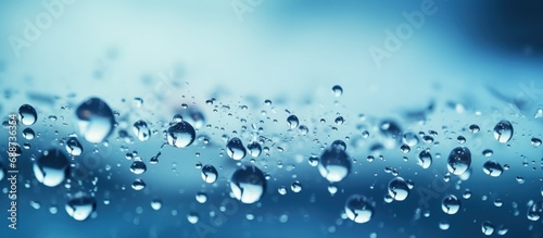 Macro view Falling blue bubbles drops of water on blur background. AI generated image