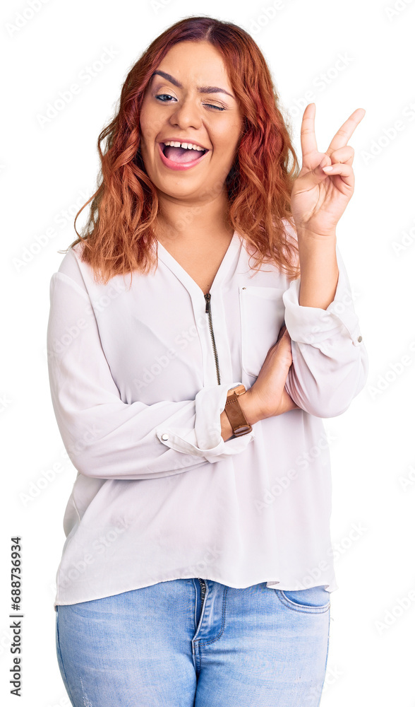 Young latin woman wearing casual clothes smiling with happy face winking at the camera doing victory sign. number two. Young latin woman wearing casual clothes smiling with happy face winking at the camera doing victory sign. number two.