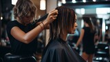 A woman is in the process of getting her hair cut at a beauty salon