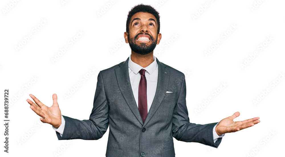 Young african american man wearing business clothes crazy and mad shouting and yelling with aggressive expression and arms raised. frustration concept. Young african american man wearing business clothes crazy and mad shouting and yelling with aggressive expression and arms raised. frustration concept.