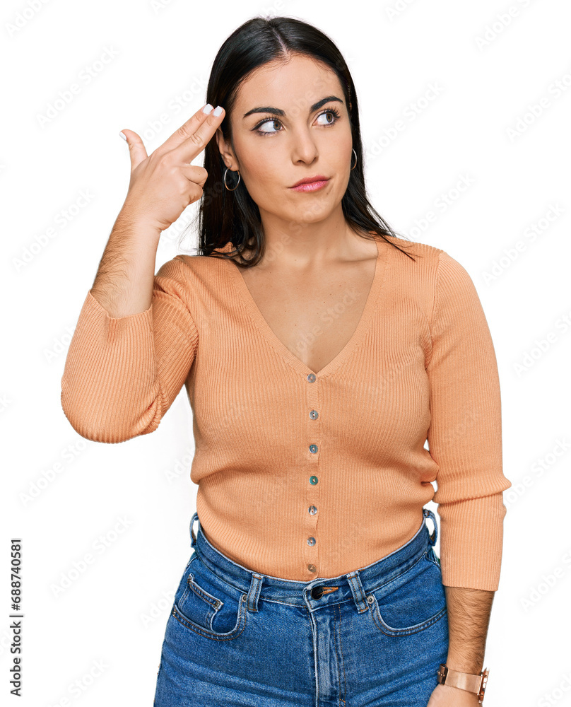Young hispanic woman wearing casual clothes shooting and killing oneself pointing hand and fingers to head like gun, suicide gesture. Young hispanic woman wearing casual clothes shooting and killing oneself pointing hand and fingers to head like gun, suicide gesture.