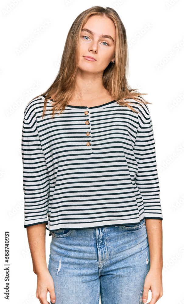 Beautiful blonde woman wearing casual clothes relaxed with serious expression on face. simple and natural looking at the camera. Beautiful blonde woman wearing casual clothes relaxed with serious expression on face. simple and natural looking at the camera.
