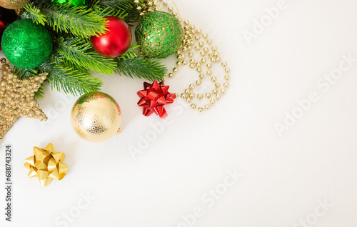 Christmas background with fir branches, red and gold decorations on a white background. Flat lay. top view with copy space