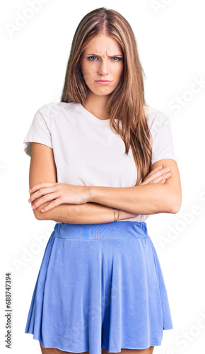 Young beautiful blonde woman wearing summer style skeptic and nervous, disapproving expression on face with crossed arms. negative person.
