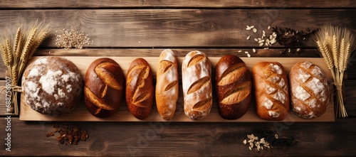 Top view of several different types of bread, wheat and rye breads on wood background