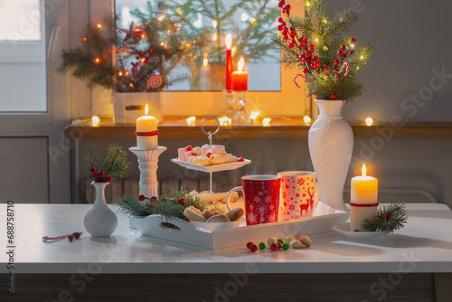 christmas decor and red cups with hot drink on kitchen