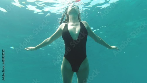 Woman, snorkeling and underwater in ocean with swimming for adventure, freedom and holiday or vacation. Diver, person and tourist in sea with scenery, summer and swimsuit for travel and exploration photo