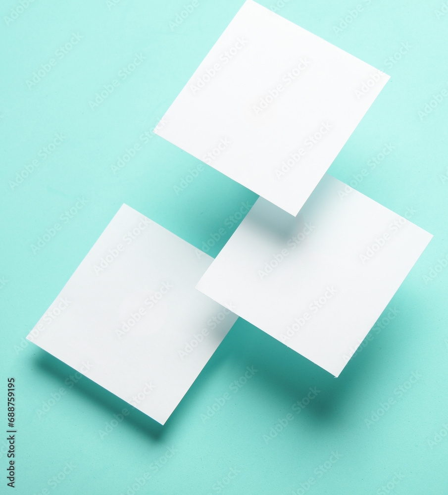Composition of floating white square memo papers on blue background. Business concept Composition of floating white square memo papers on blue background. Business concept