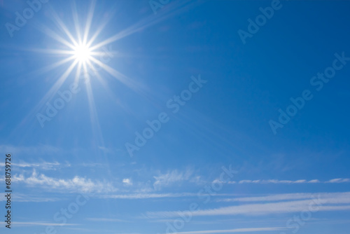 sparkle sun on blue cloudy sky background