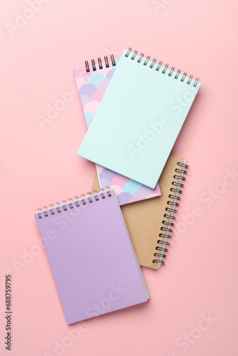 Different notepads on a pink background