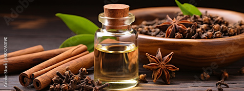 bottle, cans of cinnamon and clove extract essential oil photo