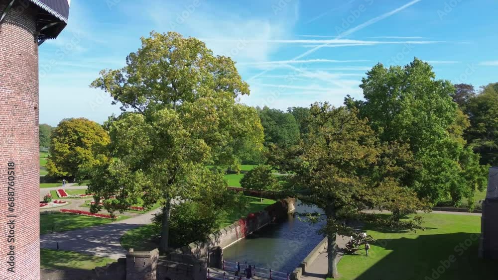 Top view of the largest castle in the Netherlands, De Haar. A beautiful quadcopter flight over the castle, the park and the water moat around the castle. A beautiful park in English style. Top view of the largest castle in the Netherlands, De Haar. A beautiful quadcopter flight over the castle, the park and the water moat around the castle. A beautiful park in English style.