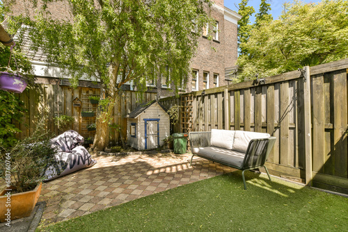 Backyard with couch and dollhouse photo