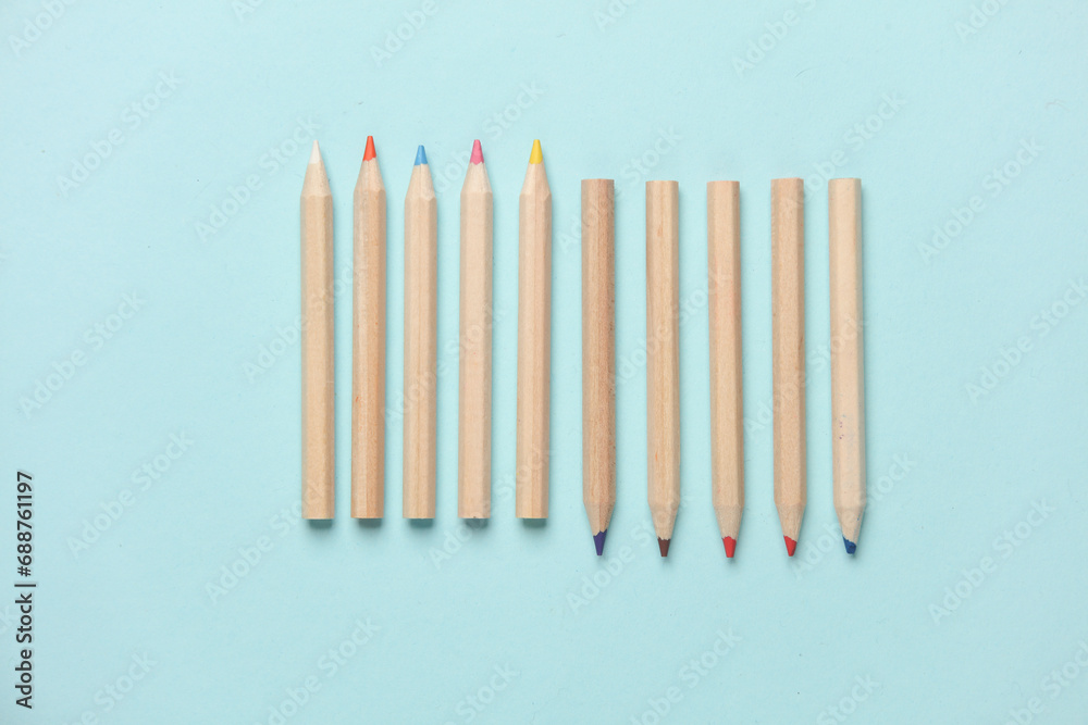 Set of wooden colored pencils on a blue background. Creativity, art Set of wooden colored pencils on a blue background. Creativity, art