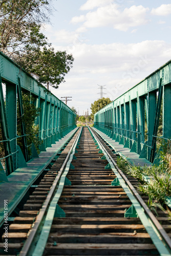 Vanishing Point Perspective on a Green Railway Bridge photo