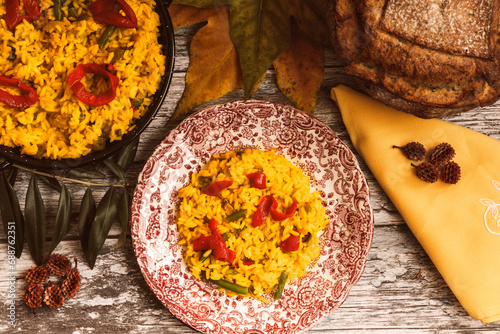 Traditional rice dish served with cheese and rustic bread photo