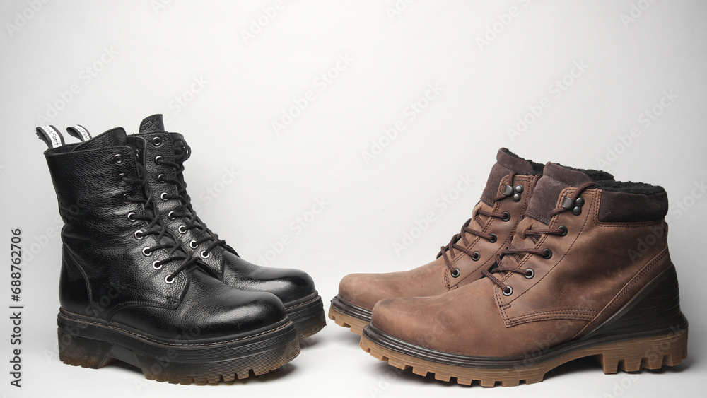 Men's and women's leather winter boots on a white background