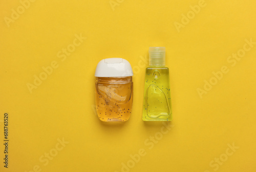 Antiseptic bottles on yellow background. Top view