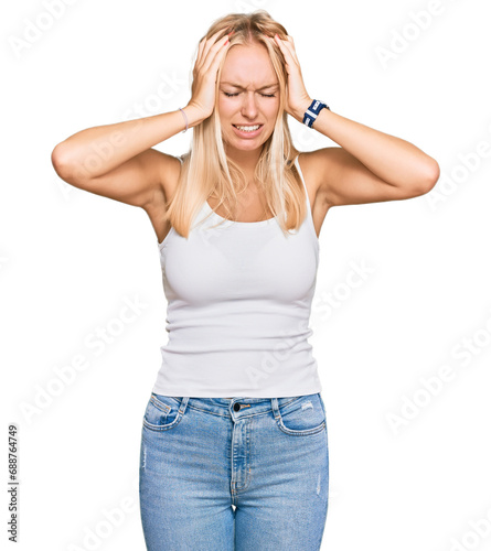 Young blonde girl wearing casual style with sleeveless shirt suffering from headache desperate and stressed because pain and migraine. hands on head.