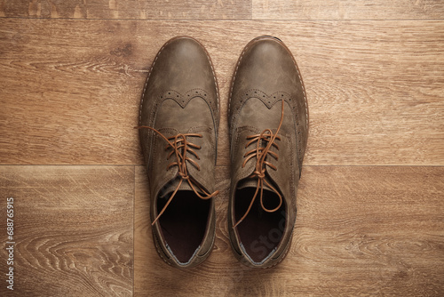 Leather men's brogue shoes on wooden floor photo