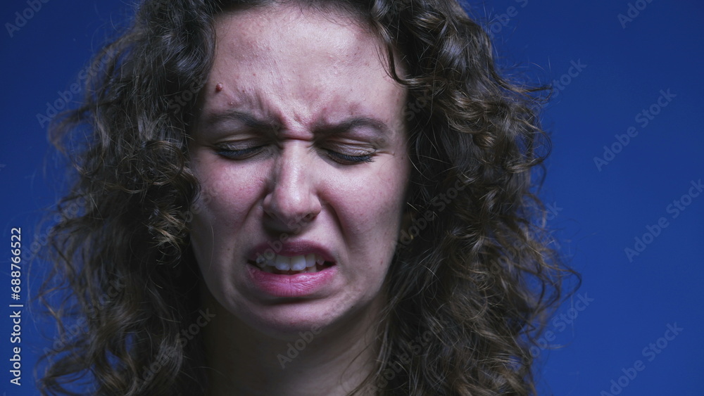 Close-up face of woman feeling disgust and contempt. 20s person feeling strong aversion, rejecting emotion Close-up face of woman feeling disgust and contempt. 20s person feeling strong aversion, rejecting emotion