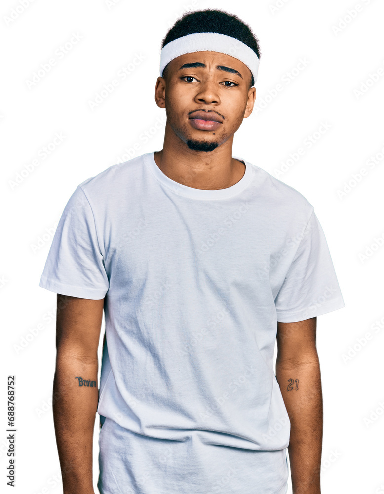 Young african american man wearing sportswear with serious expression on face. simple and natural looking at the camera. Young african american man wearing sportswear with serious expression on face. simple and natural looking at the camera.
