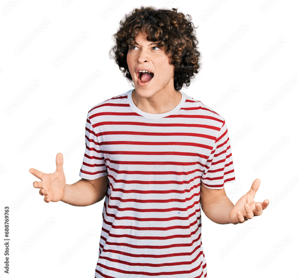 Caucasian teenager wearing casual clothes crazy and mad shouting and yelling with aggressive expression and arms raised. frustration concept. Caucasian teenager wearing casual clothes crazy and mad shouting and yelling with aggressive expression and arms raised. frustration concept.