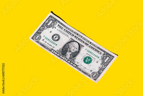 Closeup of one dollar paper currency isolated on yellow background with copy space