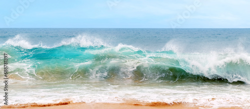 Fototapeta Naklejka Na Ścianę i Meble -  Blue and aquamarine color sea waves and yellow sand  with white foam. Marine beach background. Banner format.