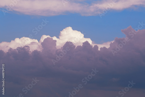 Evening sky with clouds from an airplane window, above the clouds