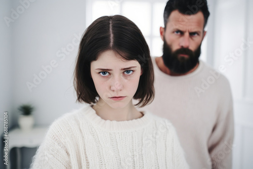 Offended teenage girl and middle aged man avoid to talk after quarrel at home, upset daughter and strict father argument, family conflict, adolescence problem