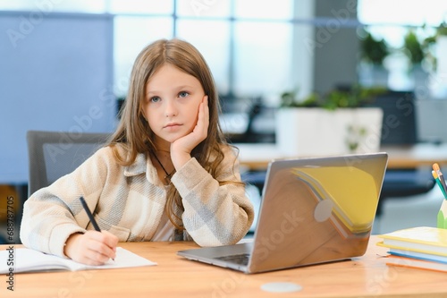 Smiling little Caucasian girl have video call distant class with teacher