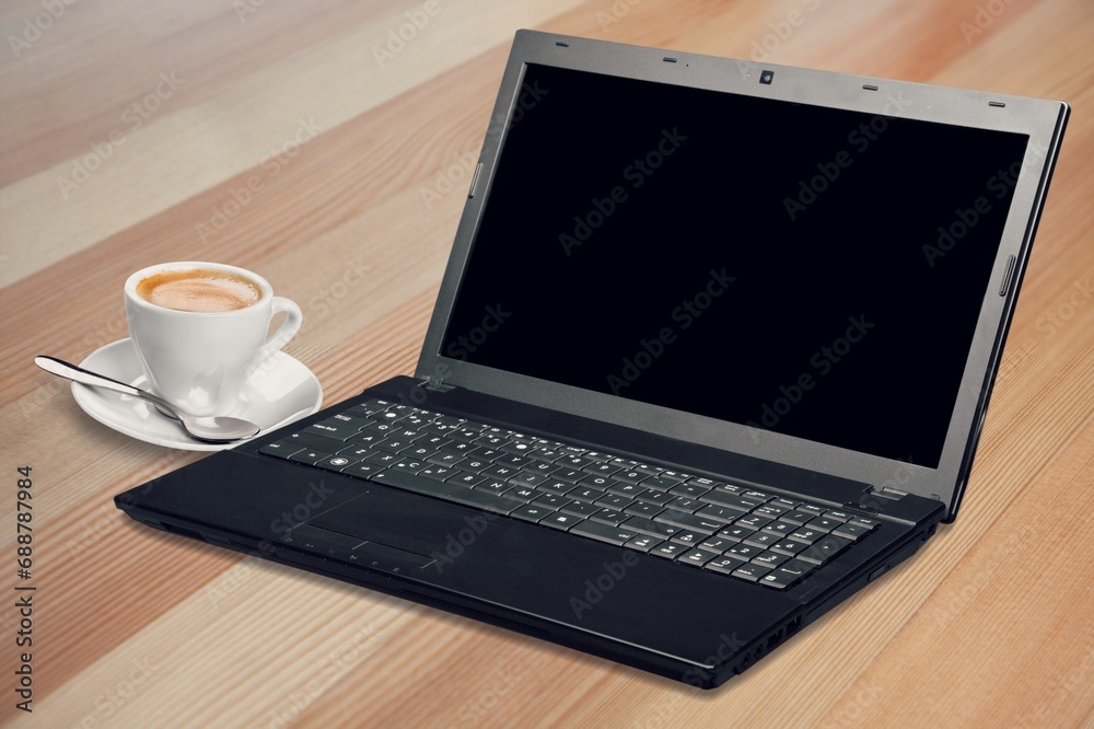 Laptop computer with blank screen on office desk Laptop computer with blank screen on office desk