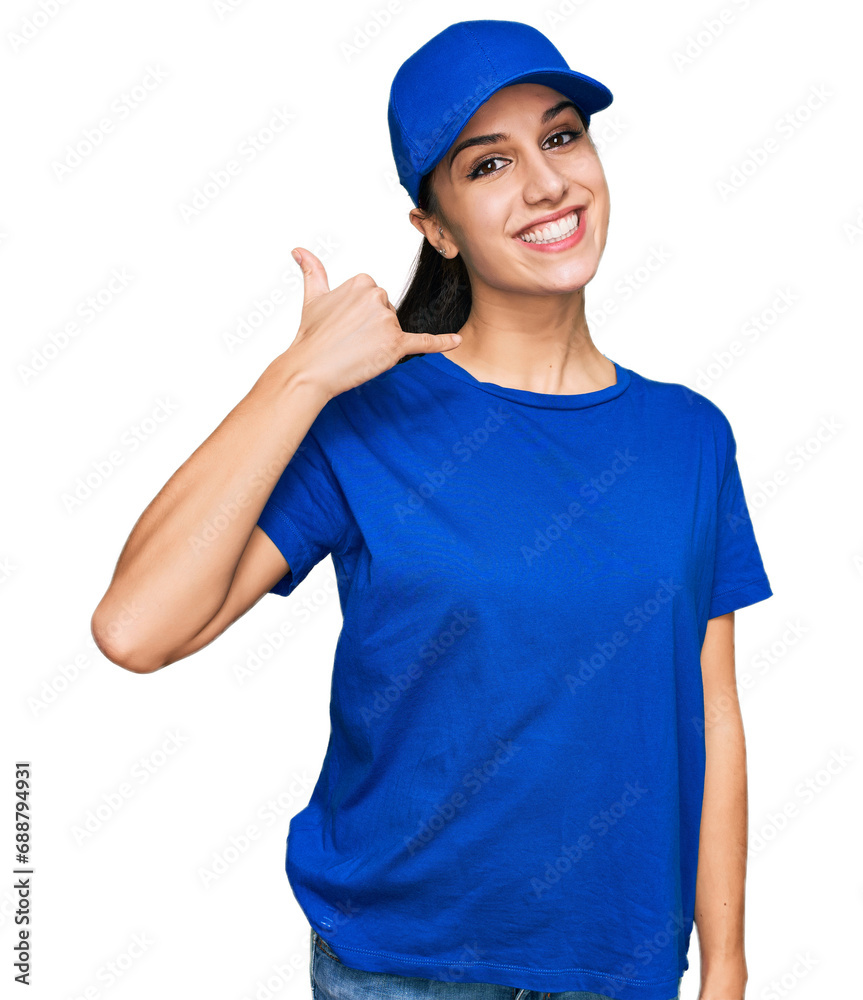 Young hispanic girl wearing delivery courier uniform smiling doing phone gesture with hand and fingers like talking on the telephone. communicating concepts. Young hispanic girl wearing delivery courier uniform smiling doing phone gesture with hand and fingers like talking on the telephone. communicating concepts.