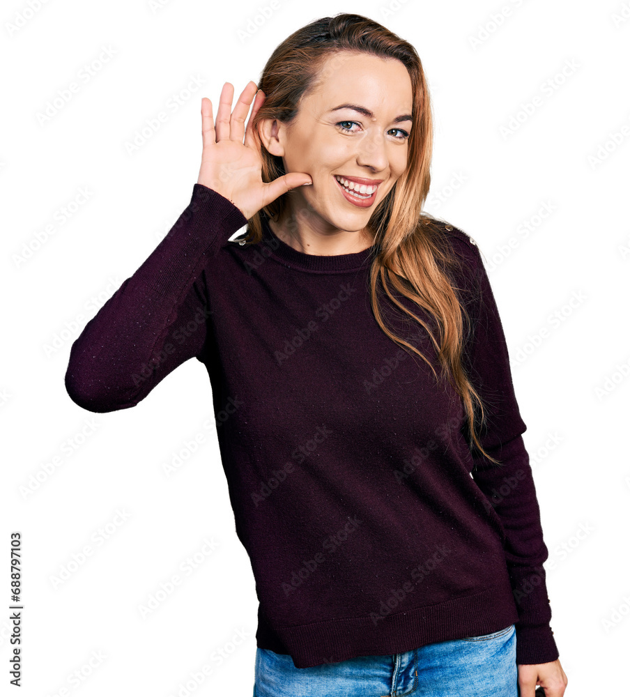 Young caucasian woman wearing casual clothes smiling with hand over ear listening an hearing to rumor or gossip. deafness concept. Young caucasian woman wearing casual clothes smiling with hand over ear listening an hearing to rumor or gossip. deafness concept.