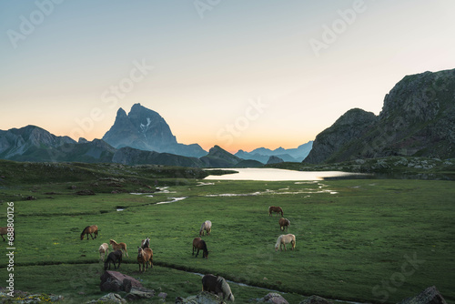 Pic du Midi d'Ossau at sunrise from the beautiful Anayet Lake in the Pyrenees / Spain