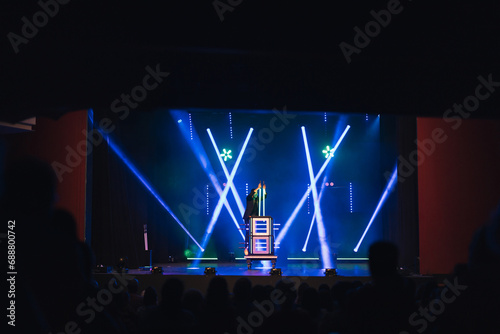Magician performing trick on stage photo