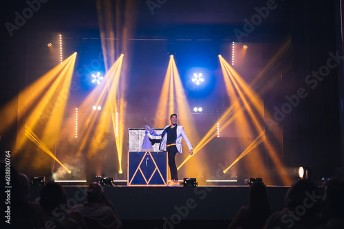 Illusionist taking stuff out of box on stage photo